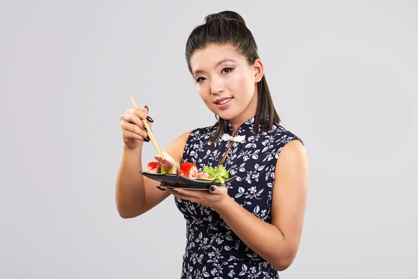 Sushi woman holding sushi