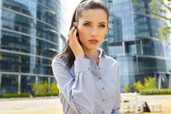 Businesswoman working with Bluetooth headset