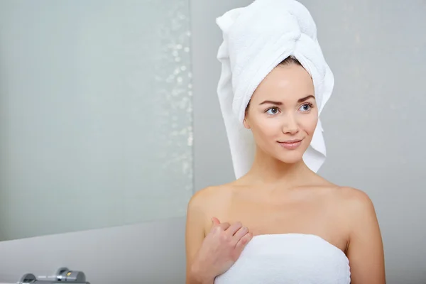 Woman wrapped in white towels
