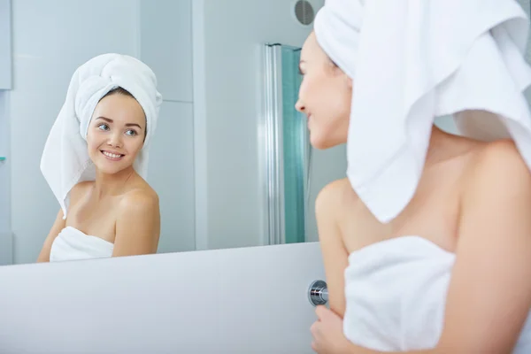 Woman wrapped in white towels