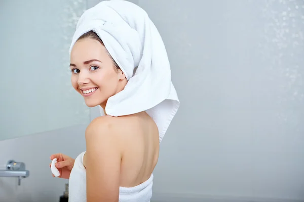 Woman wrapped in white towels