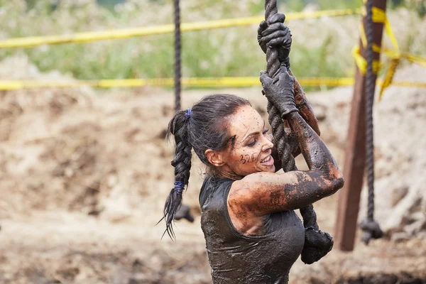 Woman in dirt on an obstacle course