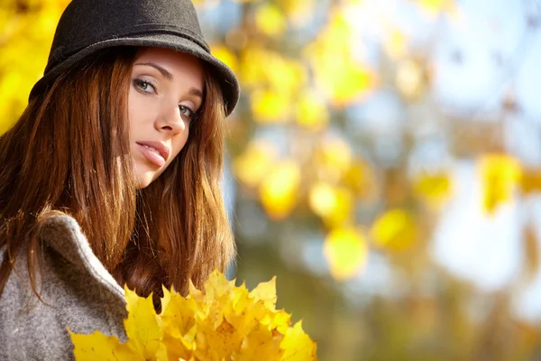 Woman with autumn leaves in hand