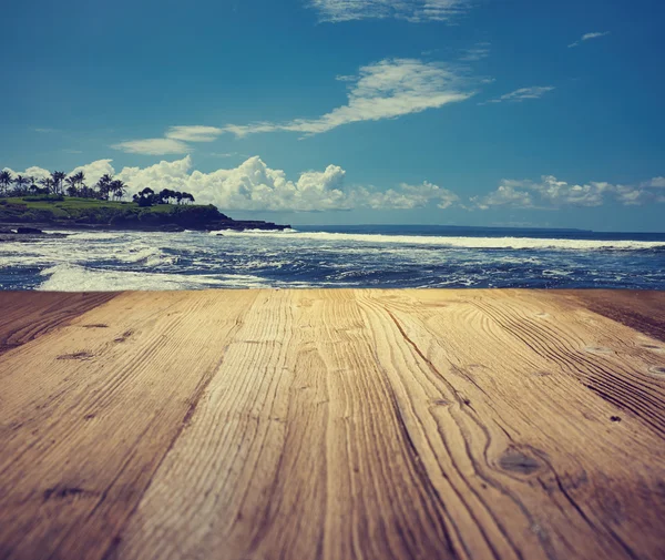 Wooden table background on the tropical beach