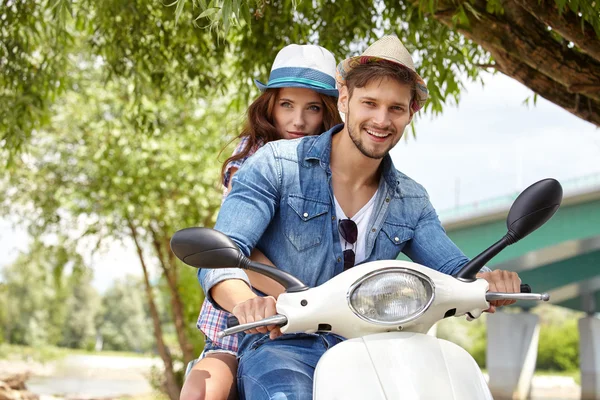 Couple together on scooter