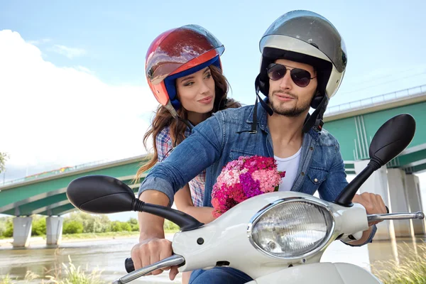 Couple on scooter driving together