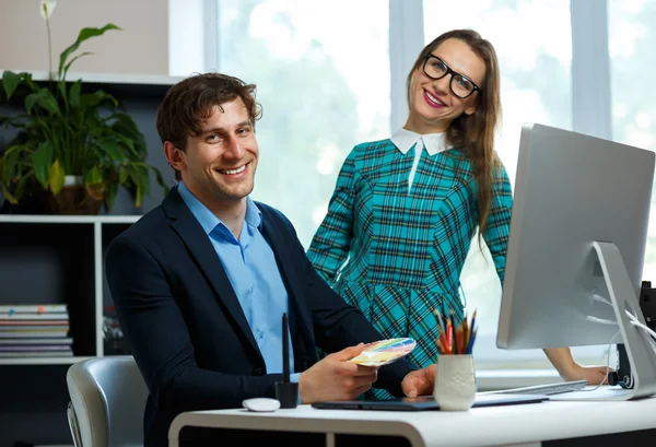 Young colleague - man and woman working from home - modern busin