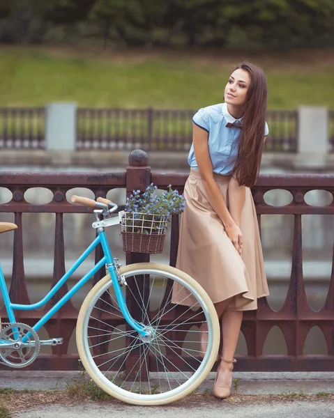 Young beautiful, elegantly dressed woman with bicycle. Beauty, f