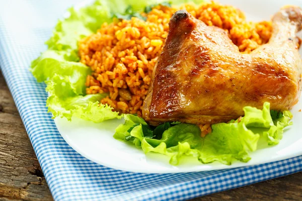 Delicious dishes from chicken thigh with rice and salad leaves