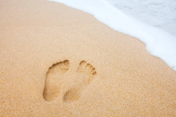 Footprints at the beach near the sea