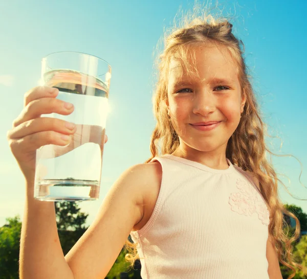 Girl holding glass with water