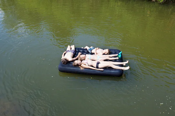 Children floating on the river