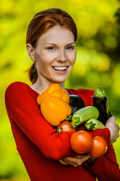Young woman in red blouse with vegetable