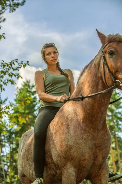 Beautiful young woman on horseback