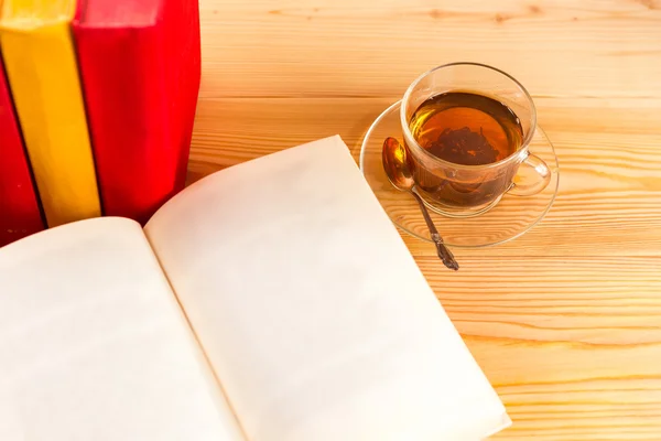 Cup of tea and books onwooden background
