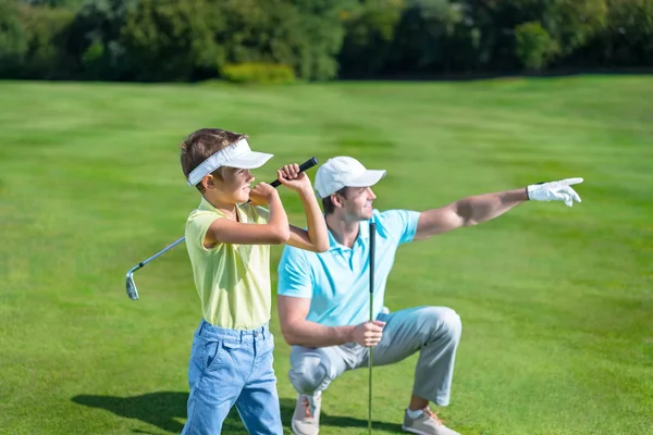 Father and son playing golf