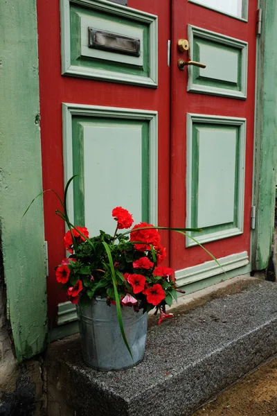 Door, mailbox and a bucket of flowers