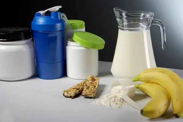 Sport Nutrition Supplement containers with jug of milk