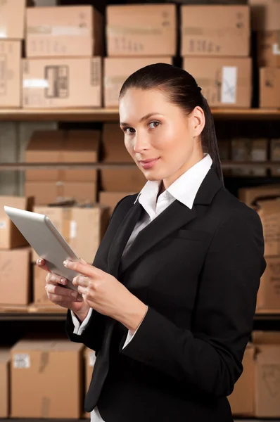 Businesswoman Using Digital Tablet In Distribution Warehouse