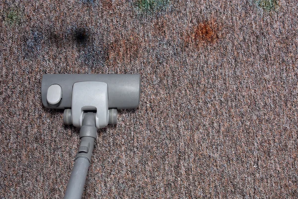 Vacuuming very dirty carpet in home