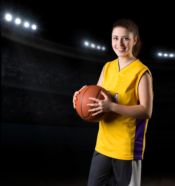 Girl basketball player in sports hall
