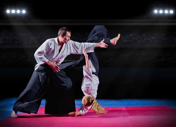 Fight between martial arts fighters at sports hall