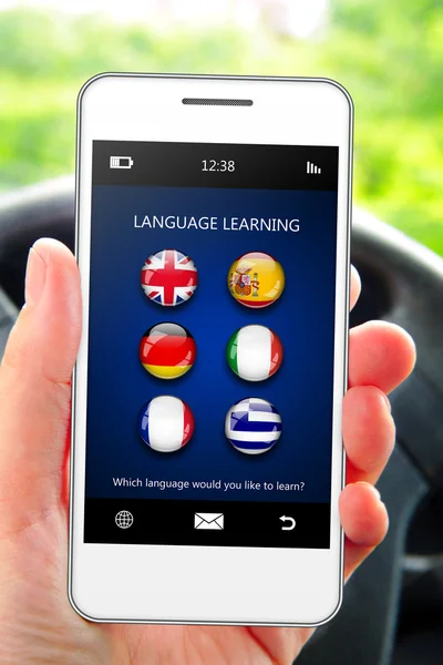 Hand holding mobile phone with language learning application