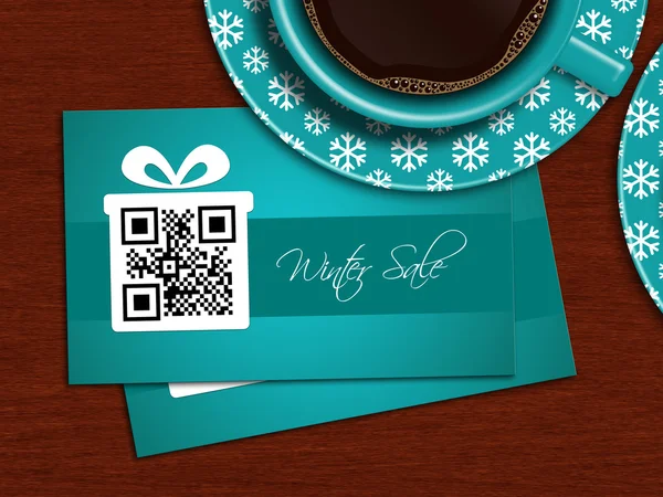 Cups of coffee with winter sale coupons on tablecloth