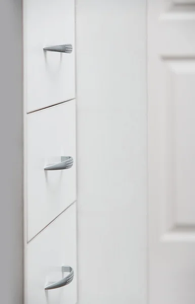 Cabinet with sliding trays and chrome handles