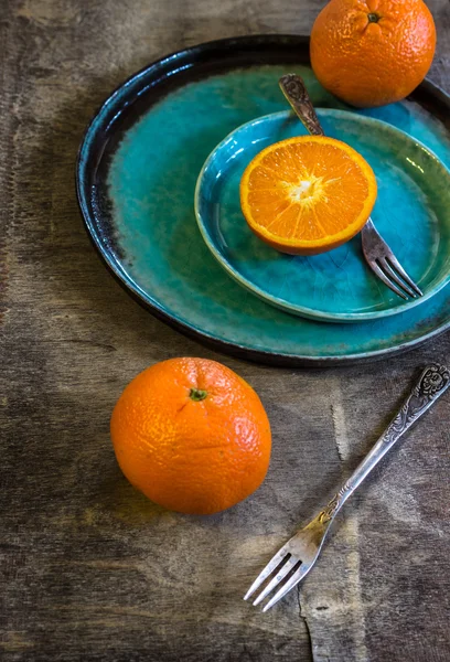 Orange fruits on turquoise plate