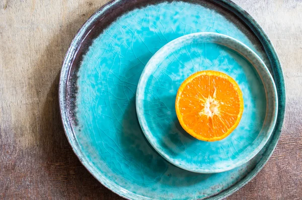 Orange fruits on turquoise plate