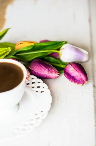 Cup of coffee with tulip flower