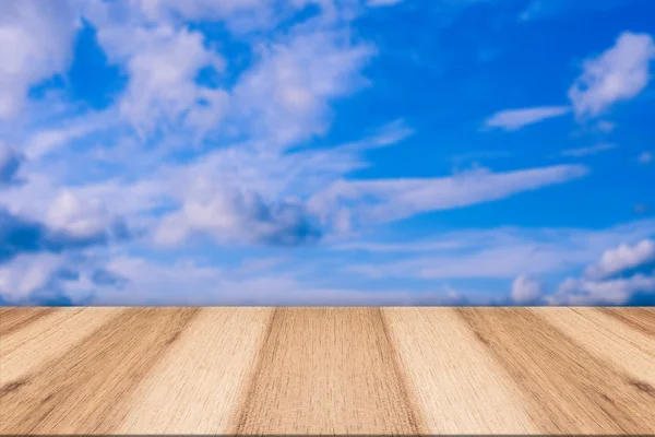 Empty wooden table and beautiful summer sky in background. Great