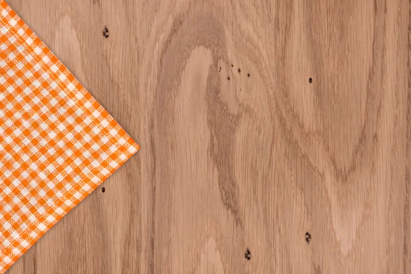 Rustic wooden boards with a orange checkered tablecloth