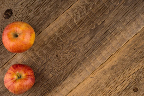 Two apples on old wood table