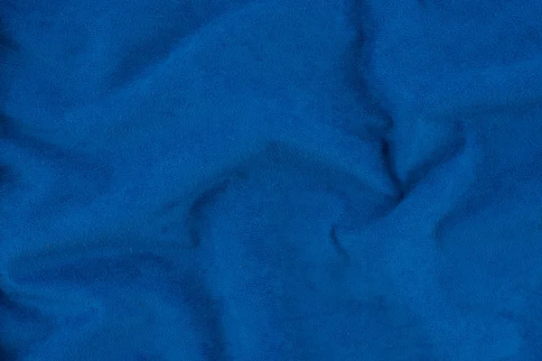 Blue wrinkled fabric texture. Close-up of soft cotton cloth, may