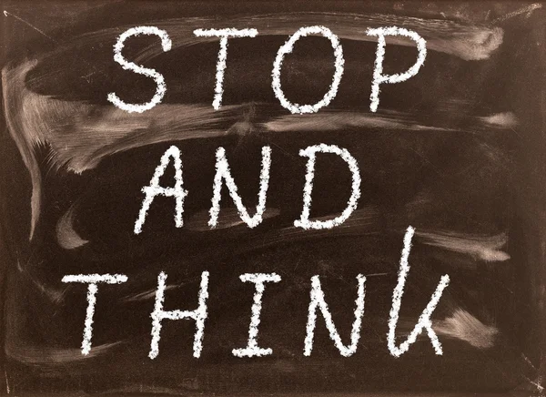 The phrase Stop and Think written on a blackboard as a reminder