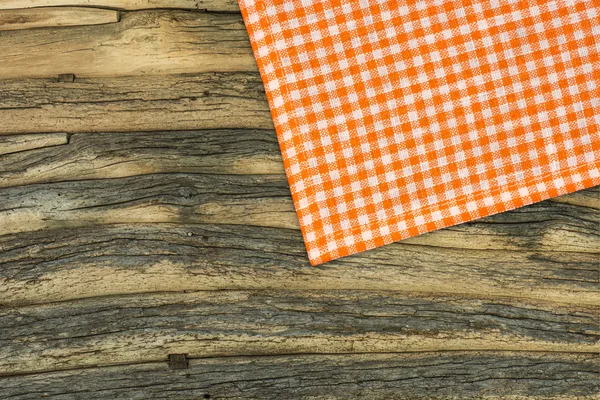 Rustic wooden boards with a orange checkered tablecloth