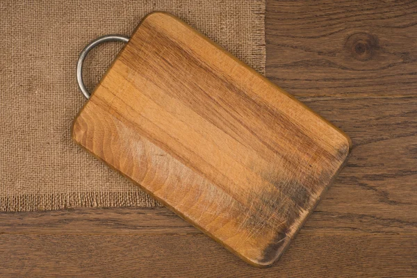 Empty vintage cutting board on planks food background concept
