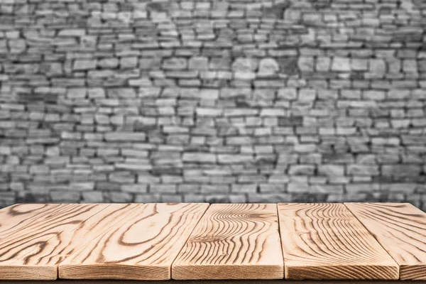 Empty top wooden table and natural stone wall background. For pr