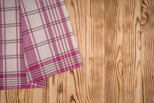 Wooden table covered with tablecloth. View from top. Empty table