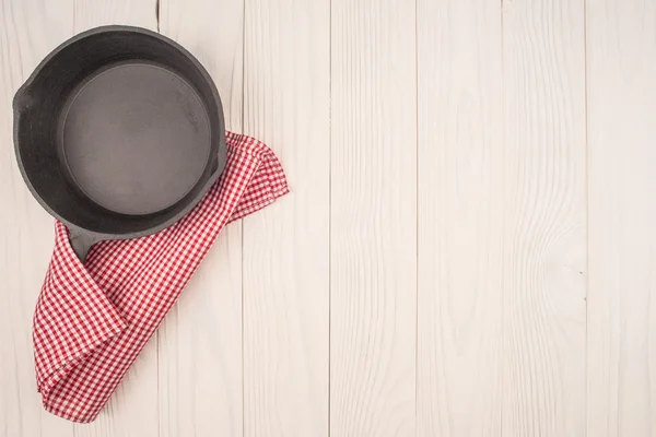 Empty pan on wooden deck table with tablecloth. Flat mock up for