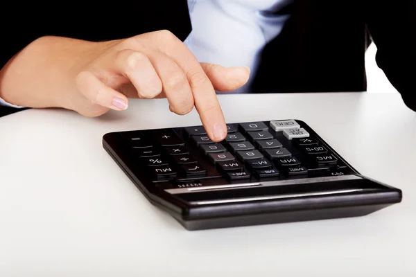 Business womans hands counts on the calculator