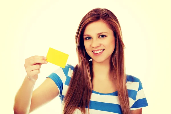 Teenage woman holding empty business card