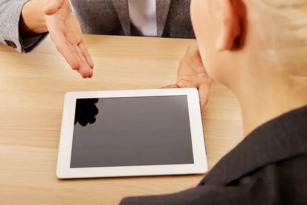 Business meeting-man showing something on tablet