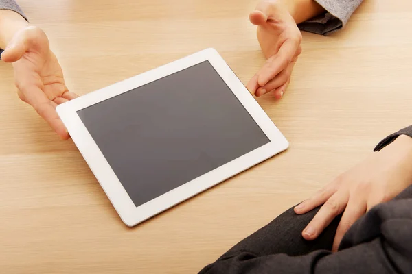 Business meeting-man showing something on tablet