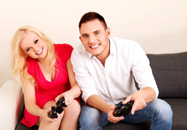 Happy young couple playing video games