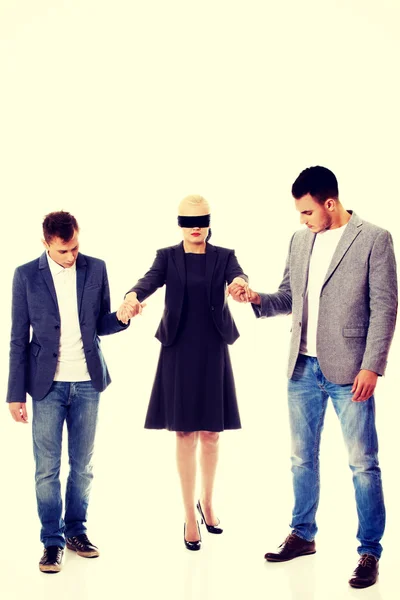 Business team-two men helping to blindfolded woman