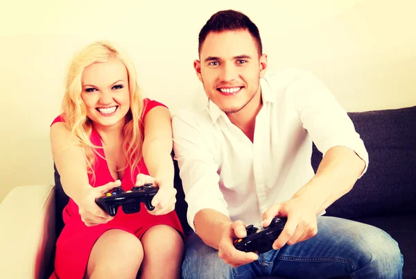 Happy young couple playing video games