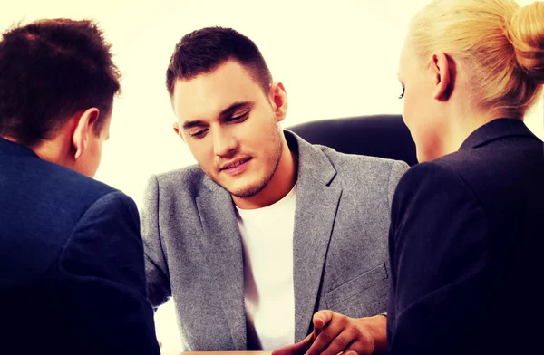 Businessman showing to people something on tablet